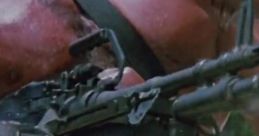 Heroic character from *Commando (1985)*, gripping a machine gun with intense focus and muscular build. Action-packed scene.