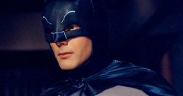 Batman from the 1966 series in classic gray and black costume, featuring iconic bat symbol and utility belt.