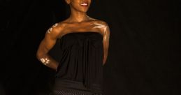 Confident model wearing a stylish black dress with polka dots, showcasing Nolga fashion against a dark backdrop.