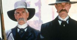 Two men in dark attire and hats pose with weapons, embodying iconic characters from *Tombstone (1993)*.