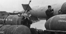 Soldiers prepare various types of bombs, including 1000 lb and 4000 lb, for military operations on a launchpad.