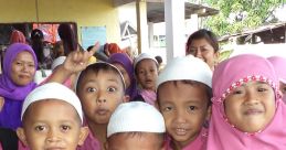 Group of cheerful children in pink uniforms and white caps, showcasing joy and friendship in a school setting.