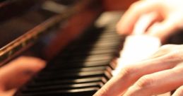 Close-up of hands playing piano keys, showcasing musical technique and artistry on a polished grand piano.