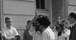 Historical moment capturing a woman surrounded by photographers, highlighting media attention on civil rights and racism.