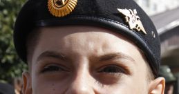 Smiling young boy in military uniform shouting with enthusiasm during a celebration, showcasing Russian military pride.