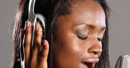 Woman singing into a microphone while wearing headphones, showcasing her passion for music and vocal performance.