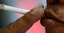 Close-up of a person holding a cigarette, emphasizing the act of smoking and the hand's grip on the cigarette.