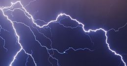 Dynamic lightning striking against a dark sky, illuminating city lights below, showcasing the power of thunderstorms.