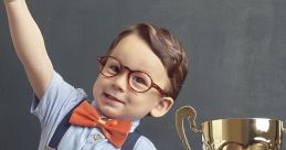 Cheerful boy in glasses gives a thumbs-up next to a shiny trophy, celebrating his winning moment with joy.