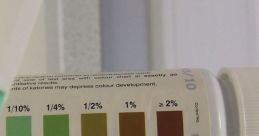 Ketone test strip with color chart indicating levels from 0.1% to 2% for accurate ketone measurement in urine.