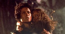 Ripley holds a child protectively while armed, embodying courage in a tense moment from "Aliens.