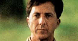 Raymond Babbitt from Rain Man, wearing a beige jacket, showcases a thoughtful expression against a blurred green background.