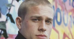 Pete Dunham from Green Street Hooligans with a determined look, against a vibrant graffiti backdrop.