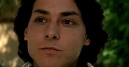 Mike Damone from "Fast Times at Ridgemont High," showcasing his confident style and charm in a casual setting.