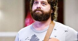 Alan Garner from "The Hangover" wearing a graphic tee and messenger bag, showcasing his quirky, laid-back style.