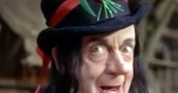 Child Catcher from Chitty Chitty Bang Bang, displaying a sinister smile and colorful attire with a large hat adorned with flowers.