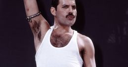 Freddie Mercury performing passionately on stage, wearing a white tank top and blue jeans, holding a microphone.