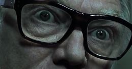 Brick Top from "Snatch" with intense gaze, showcasing his iconic glasses and menacing expression.