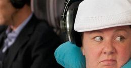 Melissa McCarthy's character looks annoyed on a plane, showcasing humorous moments from "Megan - Bridesmaids.