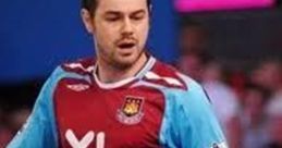 Danny Dyer wearing a West Ham United jersey, showcasing his support for the team during a vibrant football match.