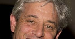 John Bercow smiles confidently, wearing a dark suit and a patterned tie, showcasing his charismatic personality.