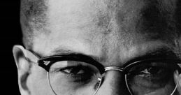 Portrait of Malcolm X showcasing his determined expression, wearing glasses and a notable ring, symbolizing his legacy.