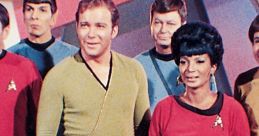 William Shatner and Nichelle Nichols with crew, showcasing iconic costumes from Star Trek: The Original Series.