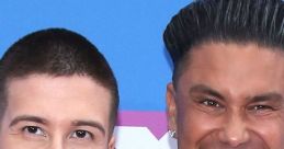 Vinny Guadagnino and DJ Pauly D smile together at a red carpet event, showcasing their vibrant personalities and style.