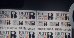 BRIT Awards 2014 backdrop featuring branding and hashtag #BRITs2014 for a memorable music celebration.