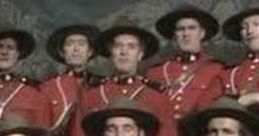 Monty Python cast in red Mountie uniforms, performing a comedic song with a backdrop of mountains. Celebrate humor and music!