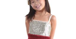 Cheerful girl in a sparkling dress with red lips design, perfect for playful occasions and fun fashion moments.