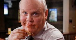 Hitchcock enjoying a messy meal, showcasing his humorous side in Brooklyn Nine-Nine's comedic moments.