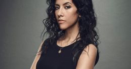 Rosa Diaz from Brooklyn Nine-Nine poses confidently in a black outfit, showcasing her police badge and strong demeanor.