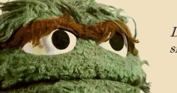 Oscar The Grouch puppet with a grumpy expression, showcasing his signature green, furry texture and iconic eyes.