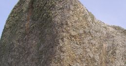 Peef Rockmartin geological formation showcasing a large, moss-covered boulder against a clear sky. Unique rock textures visible.