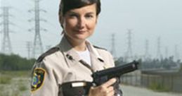 Deputy Trudy Wiegel from Reno 911! poses confidently holding a gun, showcasing her character's strength and humor.