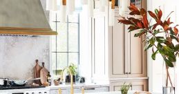 Stylish kitchen featuring a spacious island, modern stools, and elegant lighting, perfect for daily cooking and gatherings.