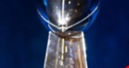 Super Bowl trophy displayed between two football helmets, symbolizing competition and excitement for Your Superbowl event.