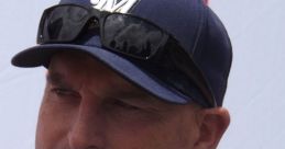 Casual portrait of Andy Harper wearing a Milwaukee cap and sunglasses, showcasing his engaging personality.