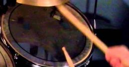 Close-up of a drummer's hands holding sticks, striking the snare and cymbals, creating an energetic drum roll.