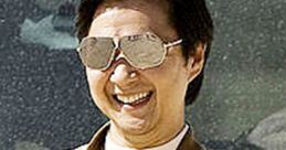 Mr. Chow in stylish sunglasses, smiling, showcasing his iconic look from The Hangover in a desert setting.