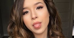 Pokimane poses playfully with a tongue-out expression, wearing a stylish olive green jacket and gray top, showcasing her vibrant style.