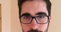 Young man with glasses and a beard, wearing a black jacket. Popular online personality known as Nogla.