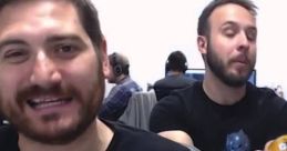 Two Funhaus hosts laughing and engaging playfully in a gaming setup, showcasing their entertaining dynamic.