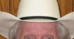 Fred Phelps, founder of Westboro Baptist Church, wearing a white cowboy hat and smiling against a wooden background.