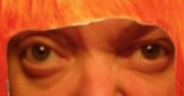 Bold expression with orange wig, embodying the quirky style of TOMAHAWK LADY. Unique and playful facial features.