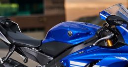 Detail of a blue Yamaha R6 motorcycle highlighting its sleek design and powerful engine components. Perfect for racing enthusiasts.