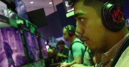 Gamer focused on gameplay at an event, using a controller and wearing headphones, surrounded by fellow gamers.