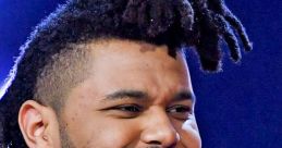 The Weeknd smiles brightly with unique hairstyle, showcasing his charismatic presence in a stylish outfit.