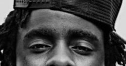 Close-up portrait of Wale, showcasing his signature style with a black cap and intricate dreadlocks.